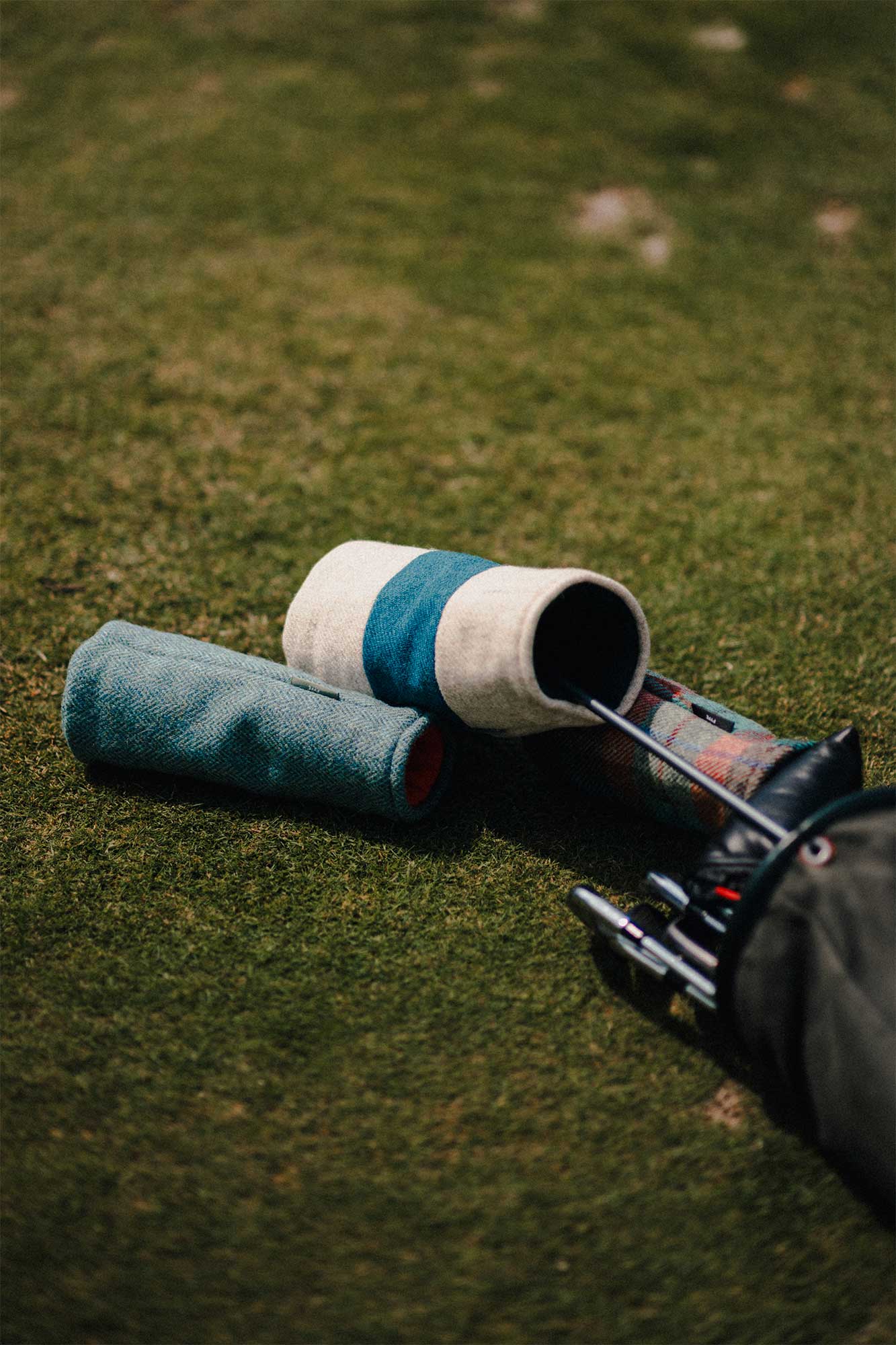 Flat lay of Fyfe Golf Harris Tweed headcovers Arran and Eriskay headcovers – A neatly arranged flat lay showcasing Fyfe Golf’s Arran and Eriskay headcovers, with their distinct patterns and premium fabric textures displayed side by side, highlighting the craftsmanship and design.