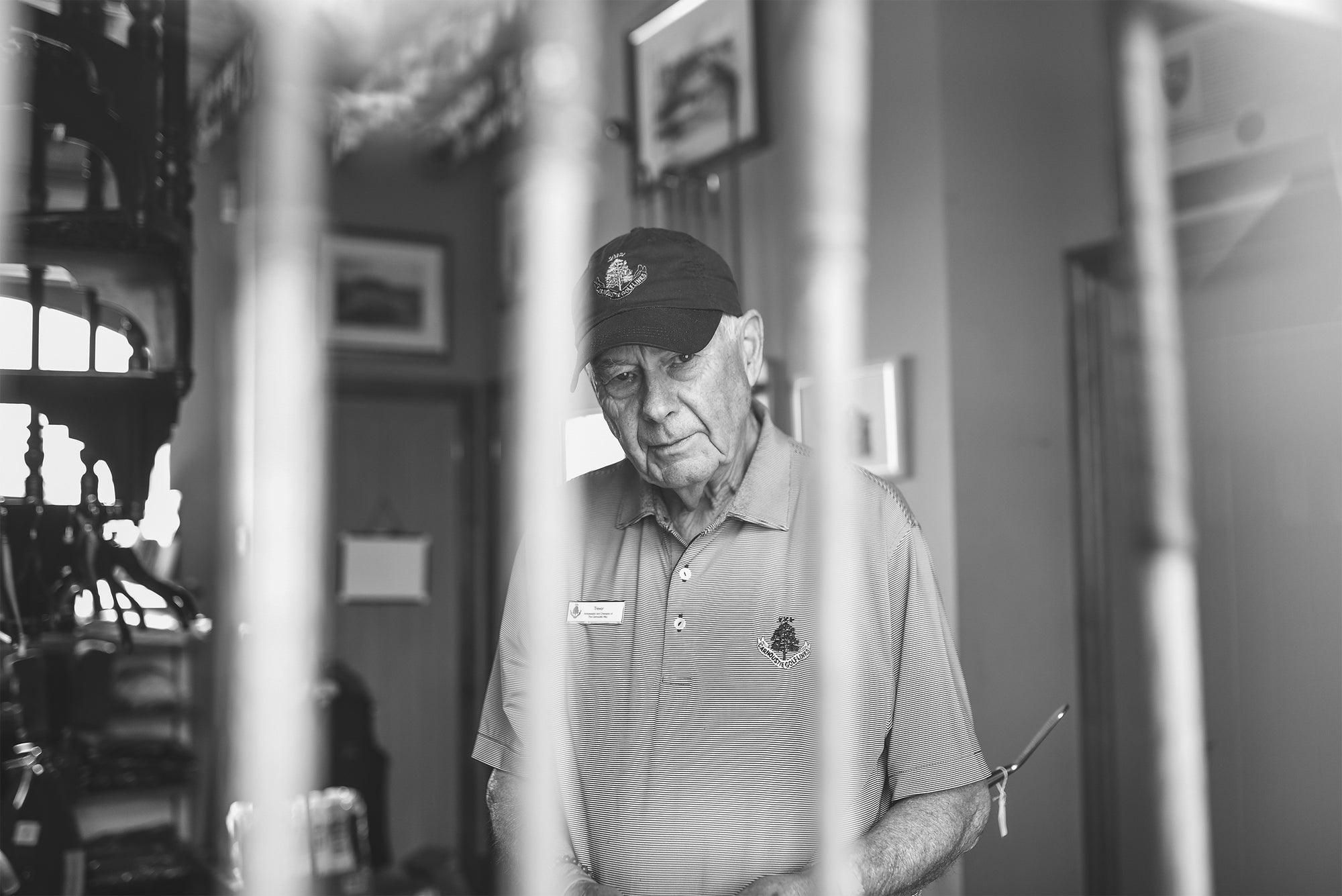 A portrait of Trevor Williamson: a black and white photo of Trevor Williamson at The Simpsons Golf Shop in Carnoustie.