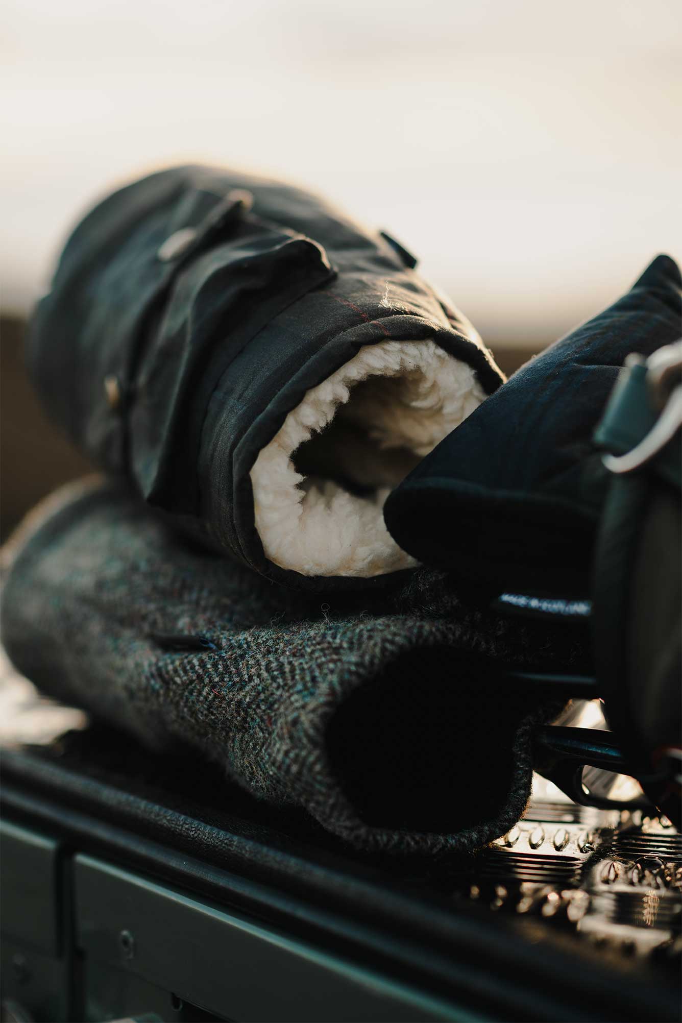 Links Wanderer Golf Headcover with Sherpa Fleece lining on a trunk  of the Land Rover– A waxed canvas headcover from Fyfe Golf's Links Wanderer collection inside a golf bag placed on a Land Rover, Defender, highlighting the fleece's soft texture, warm material, and rugged outdoor appeal, perfect for golf adventures.